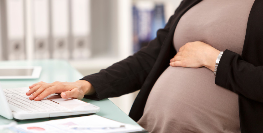 Pregnant businesswoman working on a laptop